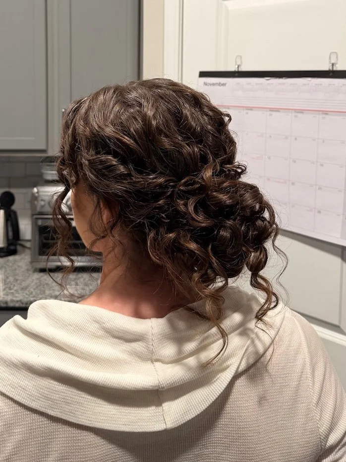 bridal updo for a brunette bride with natural curly hair