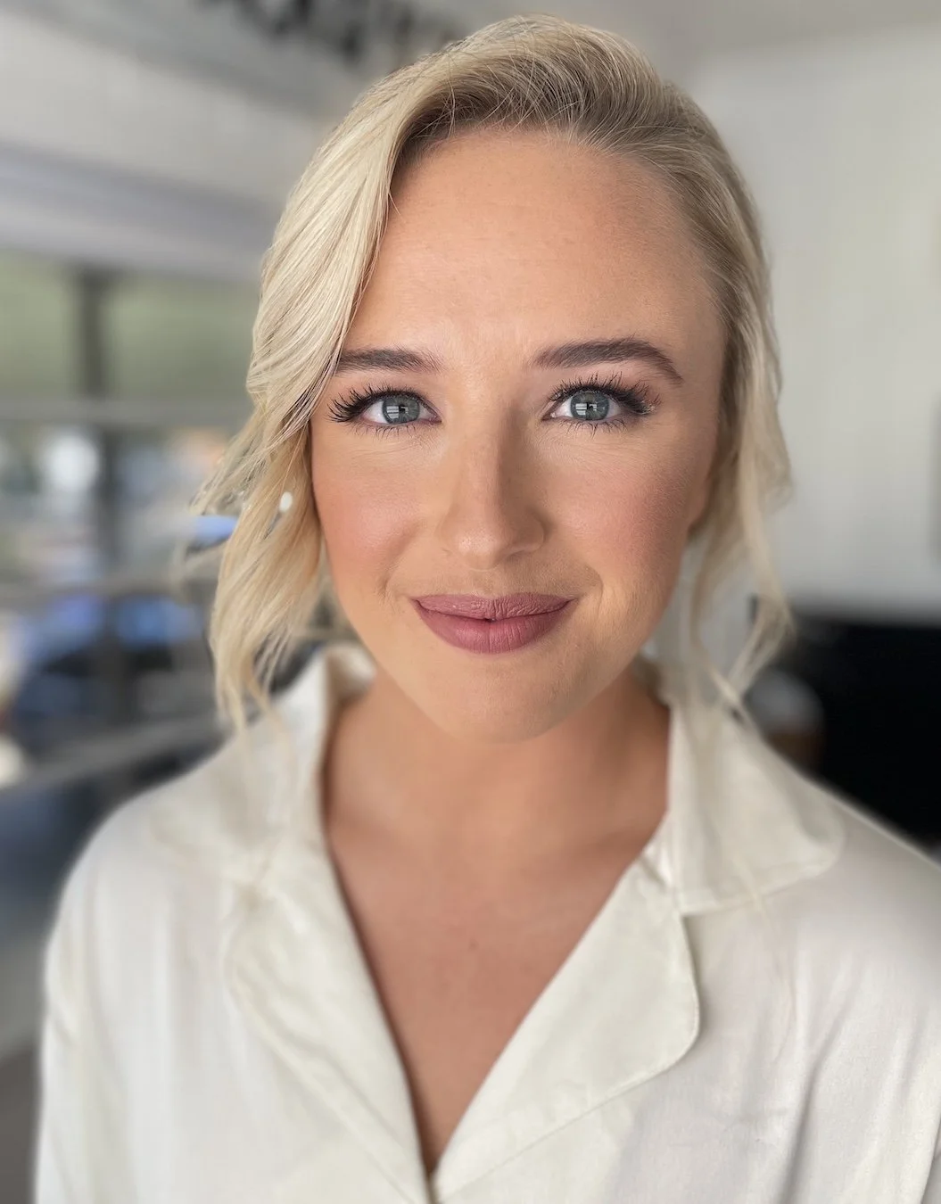 airbrush makeup on a bride with blonde hair and blue eyes