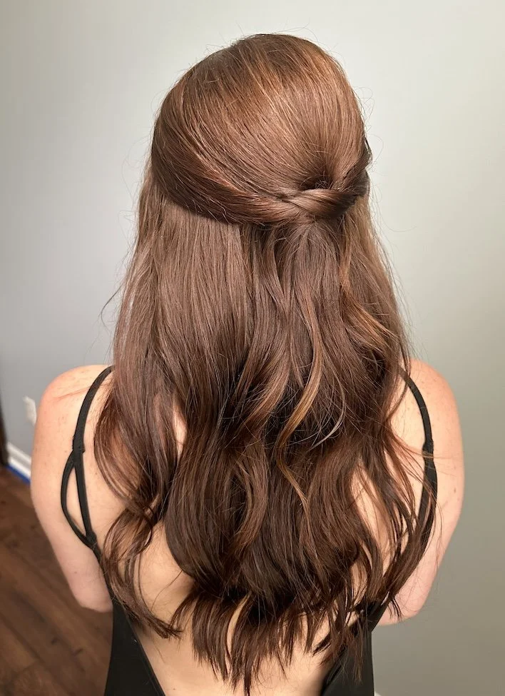 dark brunette half up half down hair style with a soft curl with a slight bend