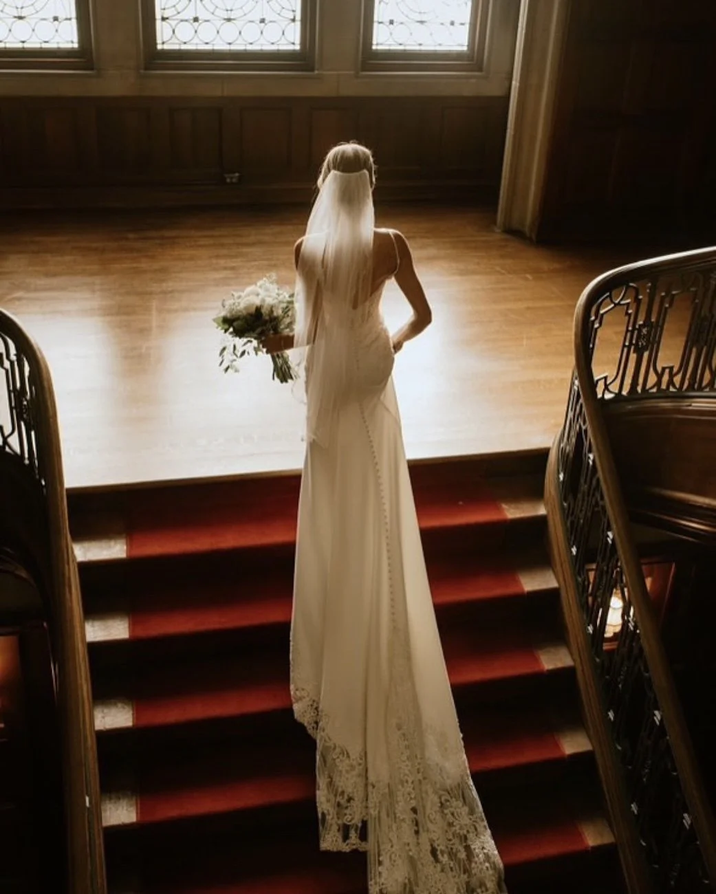 bride walking up the indoor staircase at the historic callanwolde fine arts center