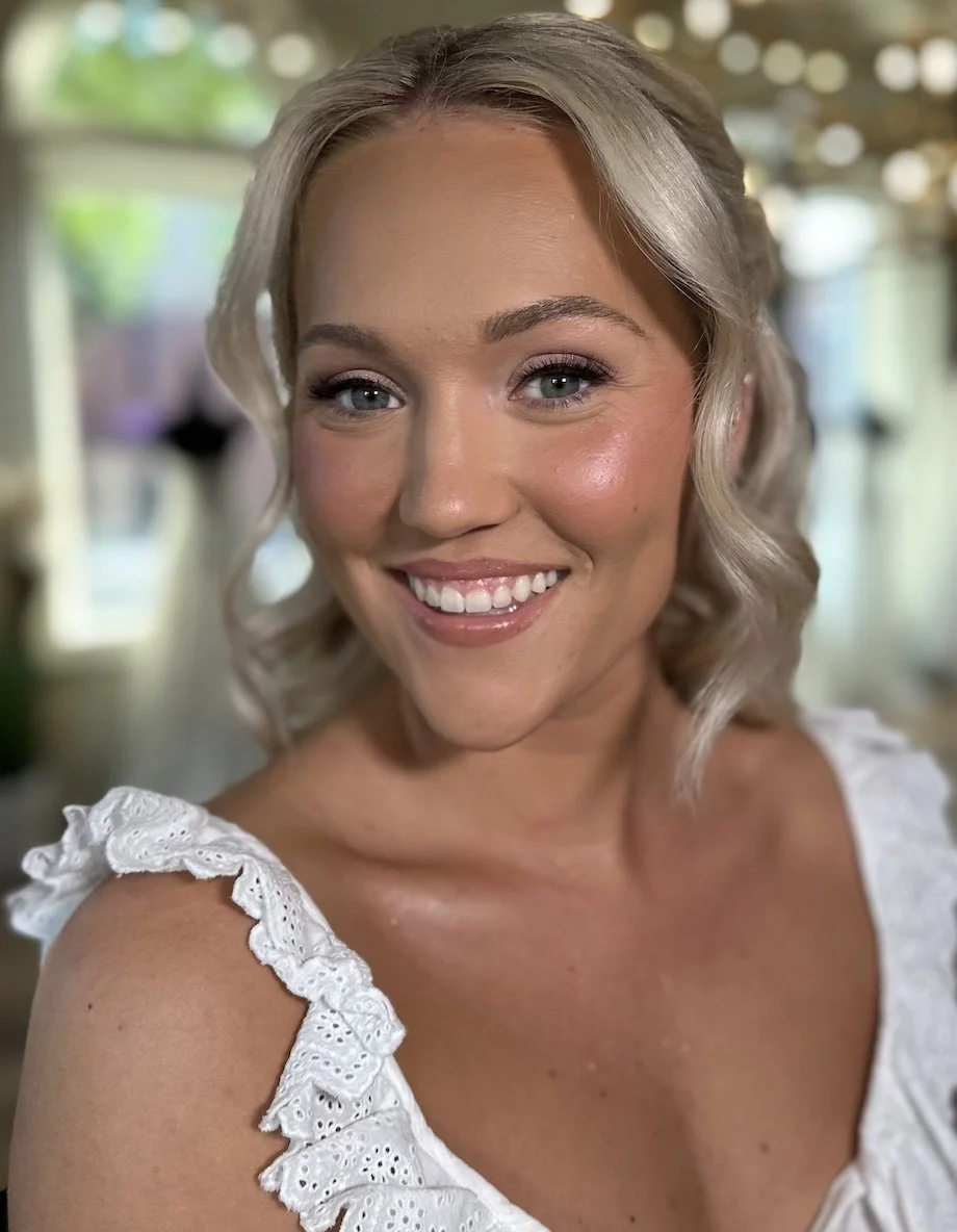 blonde bride with blue eyes and tan skin wearing natural bridal makeup