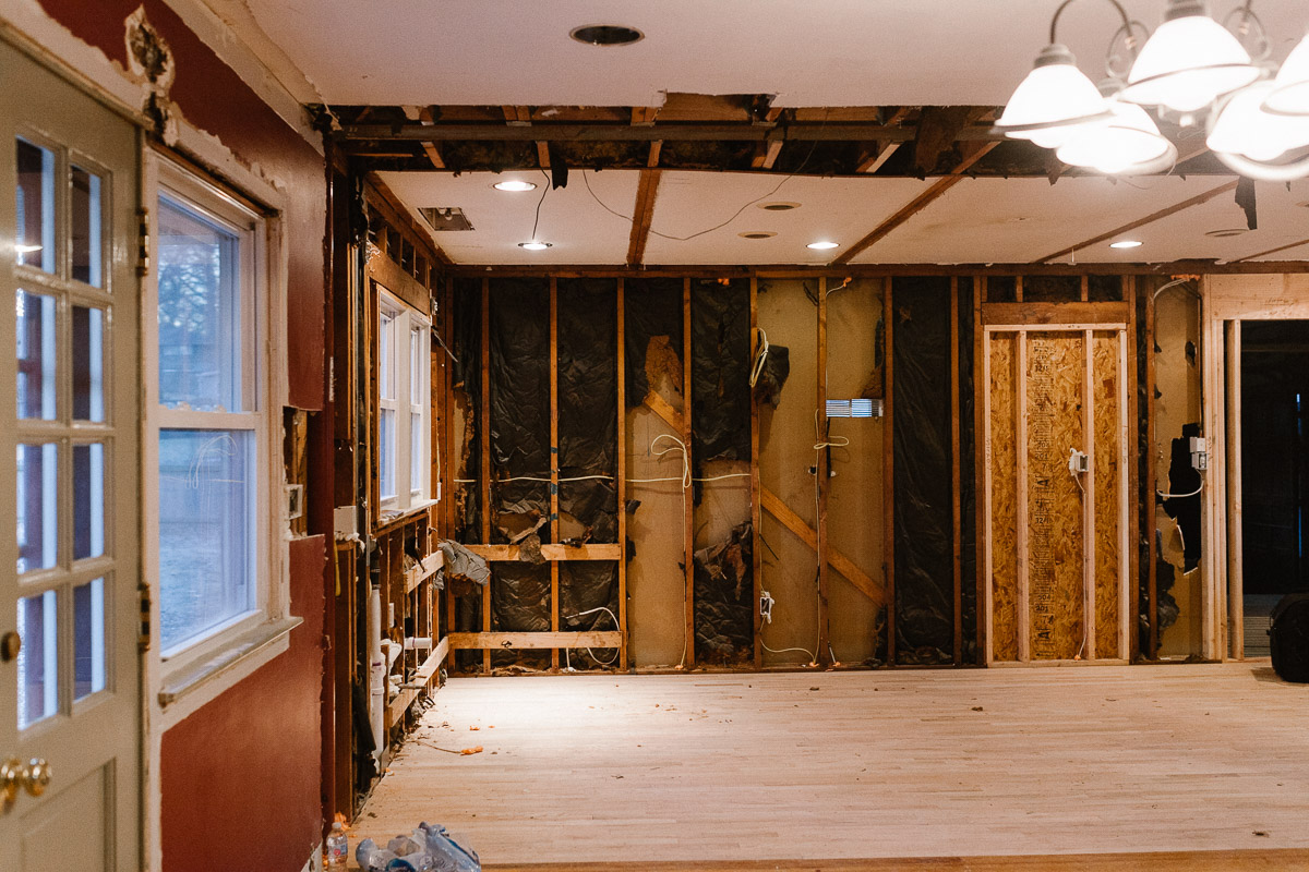 We moved the doorway heading into the garage to allow for better flow of cabinets, took out the wall (and added a 19ft steel beam). The flooring was also a different size plank so we laced in new so it would flow throughout.