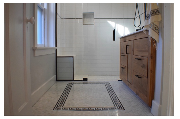 The border pattern in the floor was the focal point here, we did the pencil liner just to tie the black all together in the space and add a clean linear line around the entire room. The floors are marble hexes from Home Depot and the 4x12 Subway and Pencil Liner are both from Tile Shop.