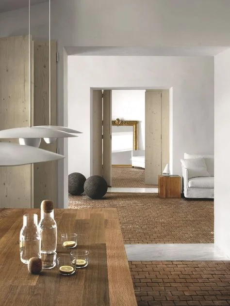 Multiple wood tones, brick, concrete, linen, and brass all can act as color and add interest to a space without making it feel to active.