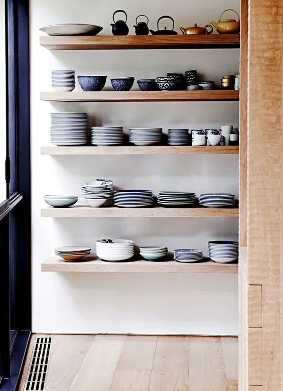 This is in no way minimalist, but what I will say that there is a color story, it has a neutral backdrop, and there is a rhyme and reason to the way in which this is organized. Image via Pinterest.