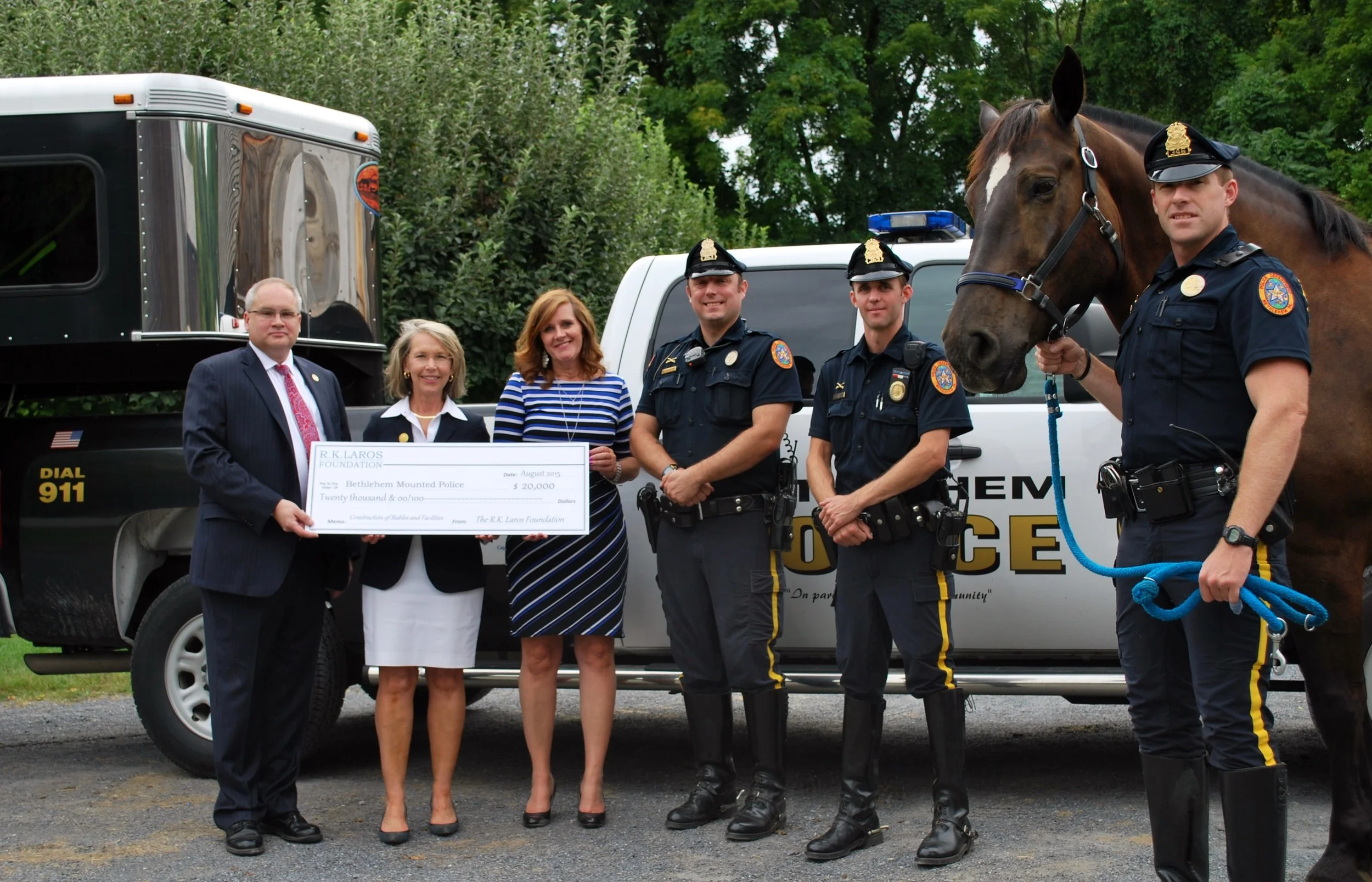 Laros Trustee Laurie Gostley Hackett and Executive Director Sharon Zondag presenting the R.K. Laros grant to the Bethlehem Mounted Police.