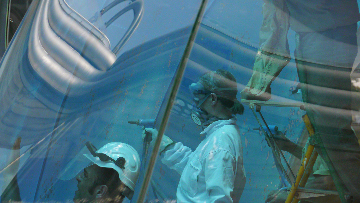 3:TGW+061511+THE+GLASS+WALL-+artist+Vicky+Colombet+and+Cloud9+team+members+sandblasting+glass+and+peeling+vinyl++P1020645.jpg