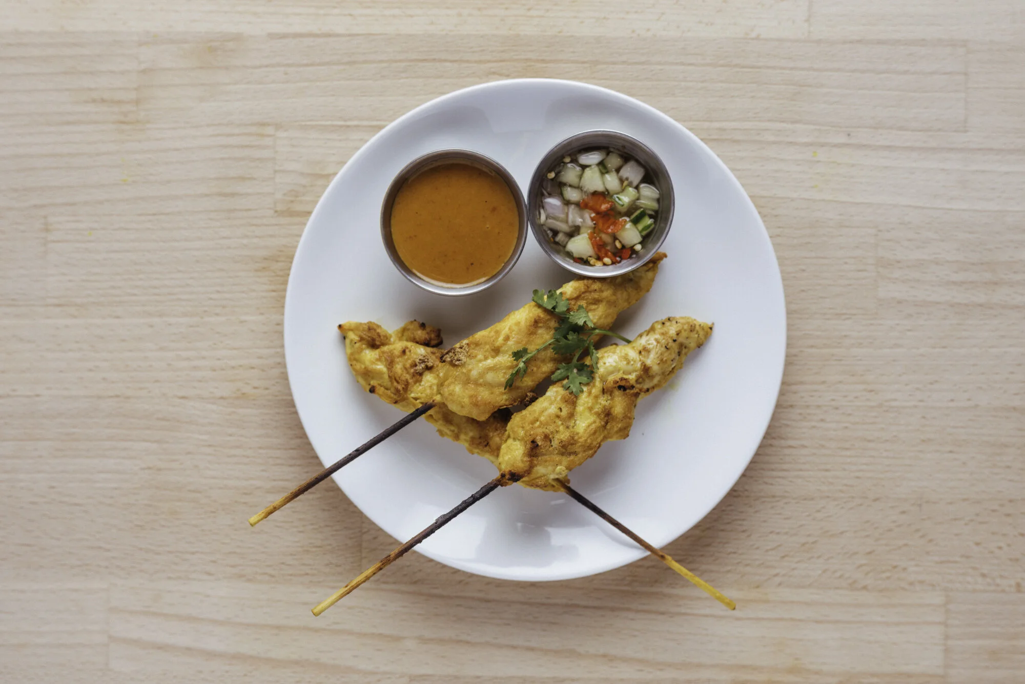   CHICKEN SATAY (GF) - 12   3 pieces of chicken tender strips marinated with coriander, cumin seeds, kosher salt, turmeric, galangal, coconut milk, coriander seeds.     ADD SATAY +2   