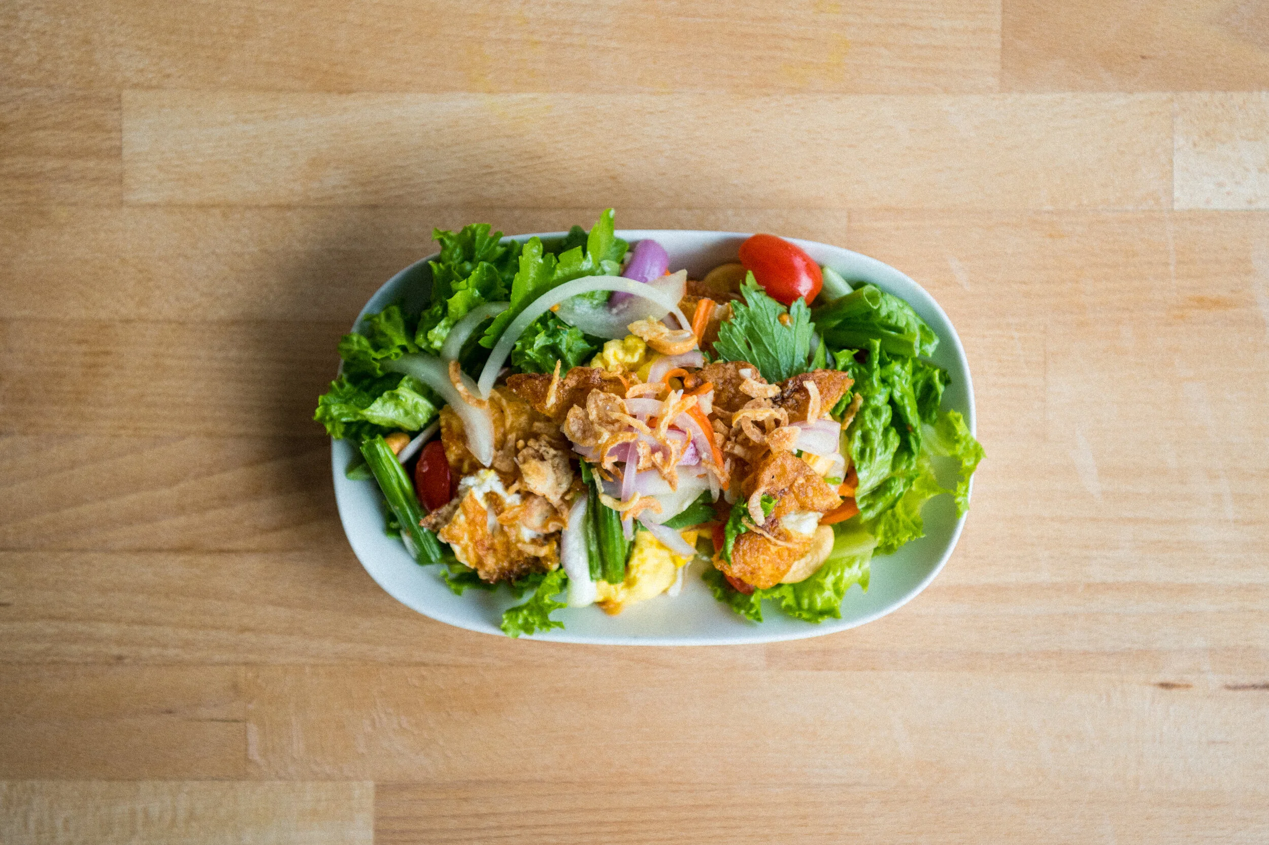   FRIED EGG SALAD (GF) - 15   eggs, asian celery, shallots, green onions, onions, green lettuce, thai chili, tomatoes, fish sauce, cashew nuts, lime juice 