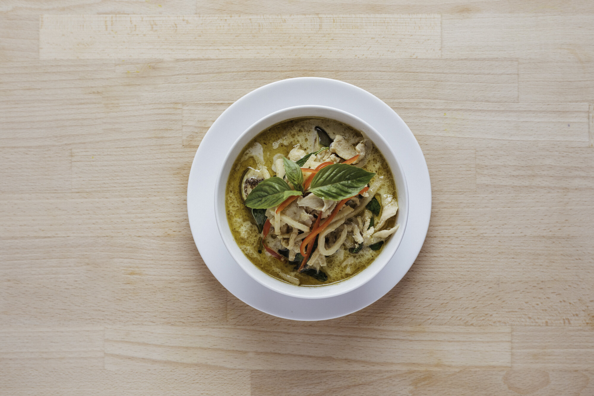   GREEN CURRY (GF) - 18     choice of chicken or tofu     with coconut milk, chili, garlic, ginger, thai eggplants, lime leaves, bamboo shoots, fish sauce, thai basil, shrimp paste 