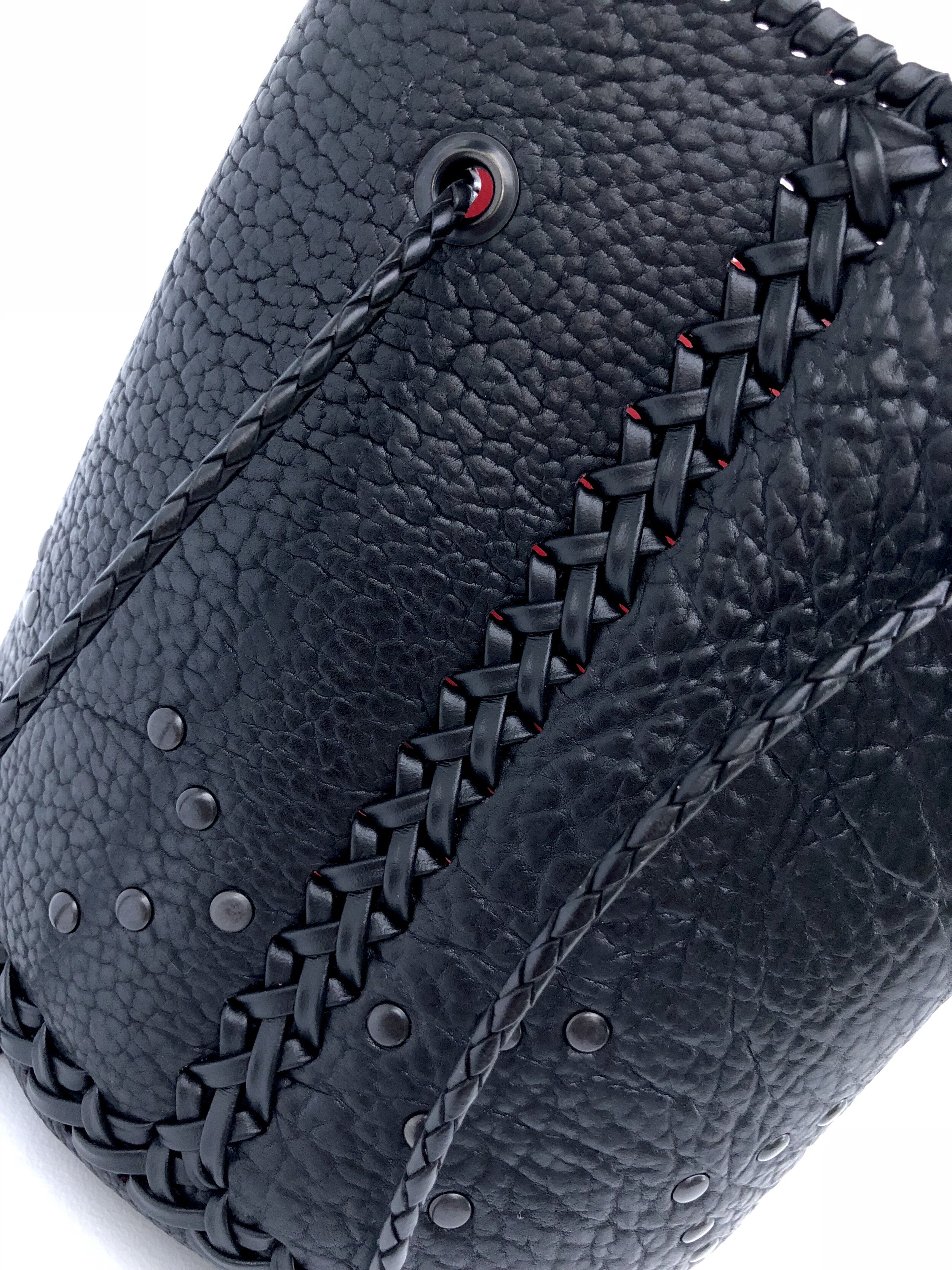Custom leather bucket bag braid detail.