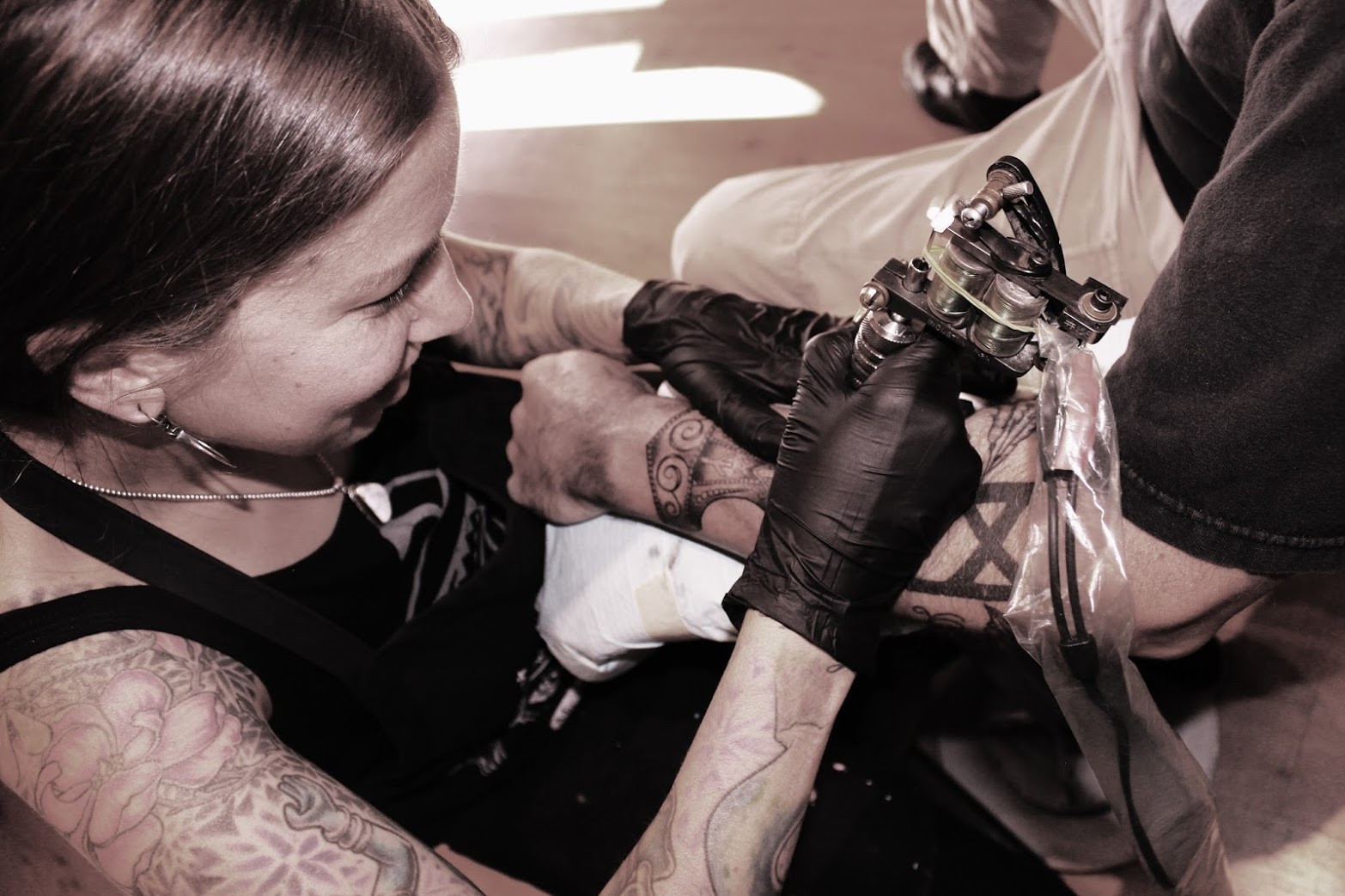plus.google.com A man gets a tattoo on his arm by Valkyrie Tattoo artist Jennifer Untalan, who spoke at the recent event "Sonoma Ink." A discussion took place during the event, held by Untalan and two other key note speakers, of the taboo and culture surround tattoos.