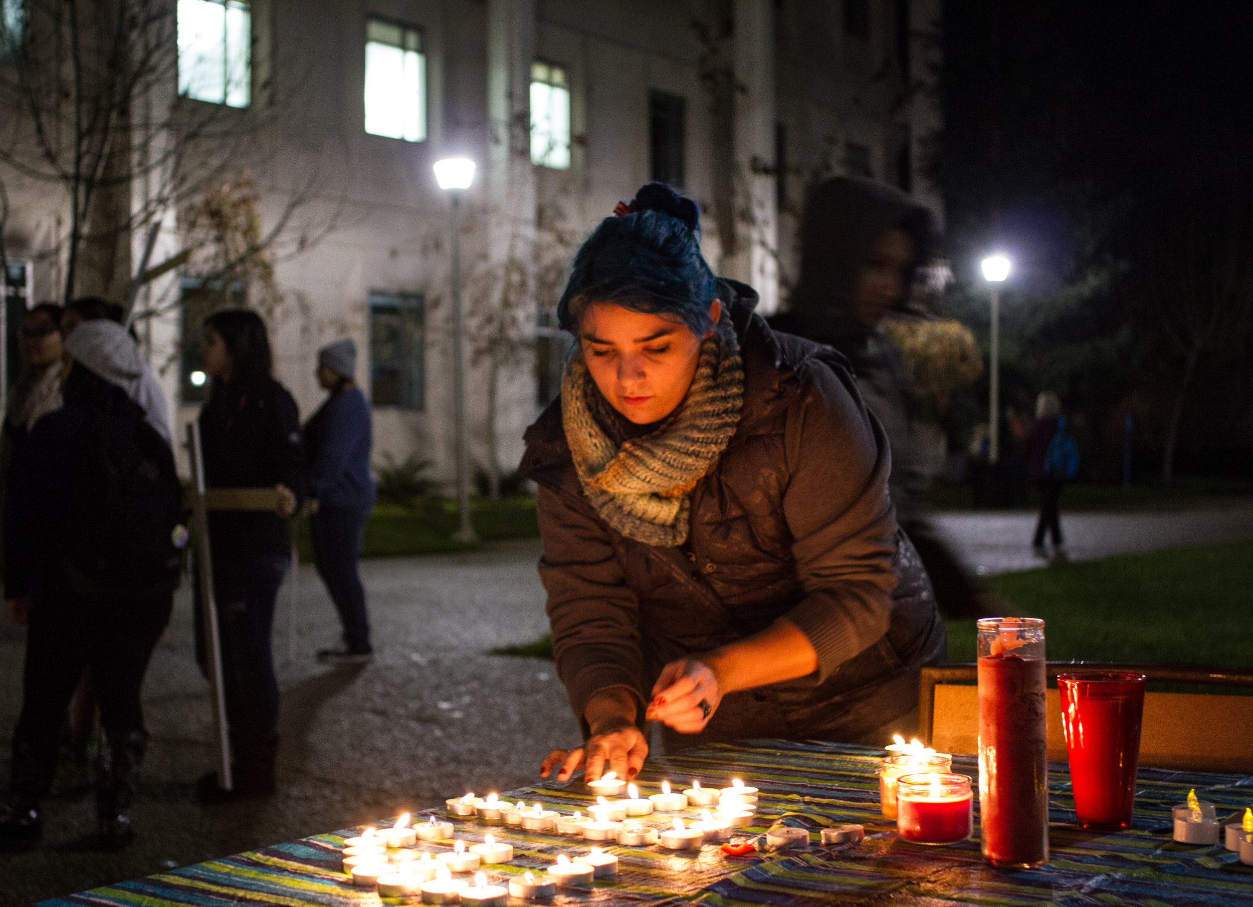 STAR // Gustavo Vasquez Emily Grawford, a Chicano and Latino studies major at Sonoma State University, lit candles in solidarity for the 43 missing college students in Mexico during a protest on campus Wednesday.