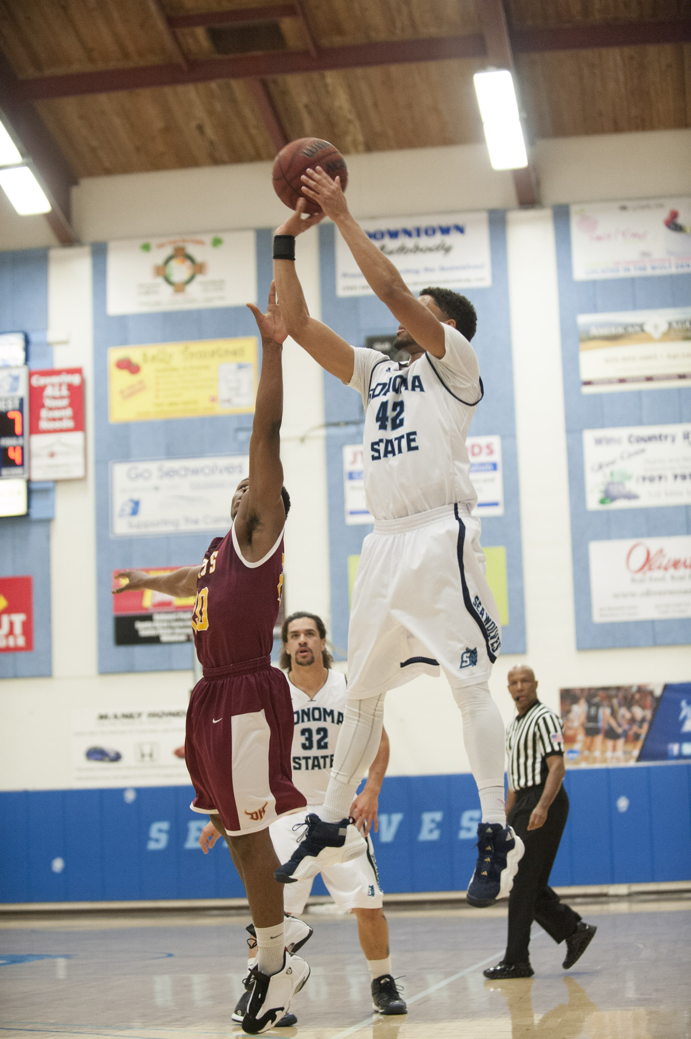 STAR // Connor Gibson Left/Middle: Senior JJ Mina and Junior James Davis rise above defenders as they lead the team in scoring with 18 points each. Right: Sophomore Nathan Molony-Benjamin contributed in the paint.