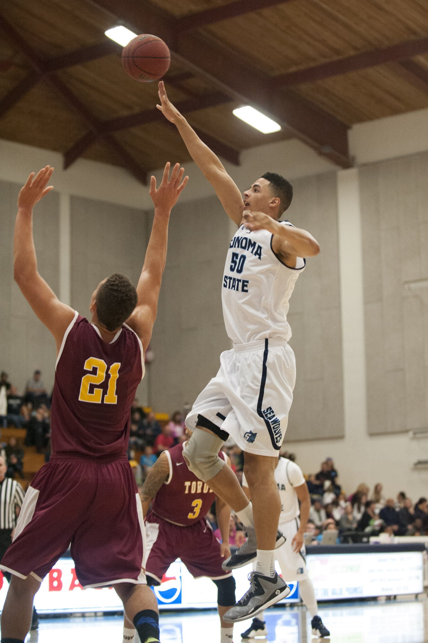 STAR // Connor Gibson Left/Middle: Senior JJ Mina and Junior James Davis rise above defenders as they lead the team in scoring with 18 points each. Right: Sophomore Nathan Molony-Benjamin contributed in the paint.