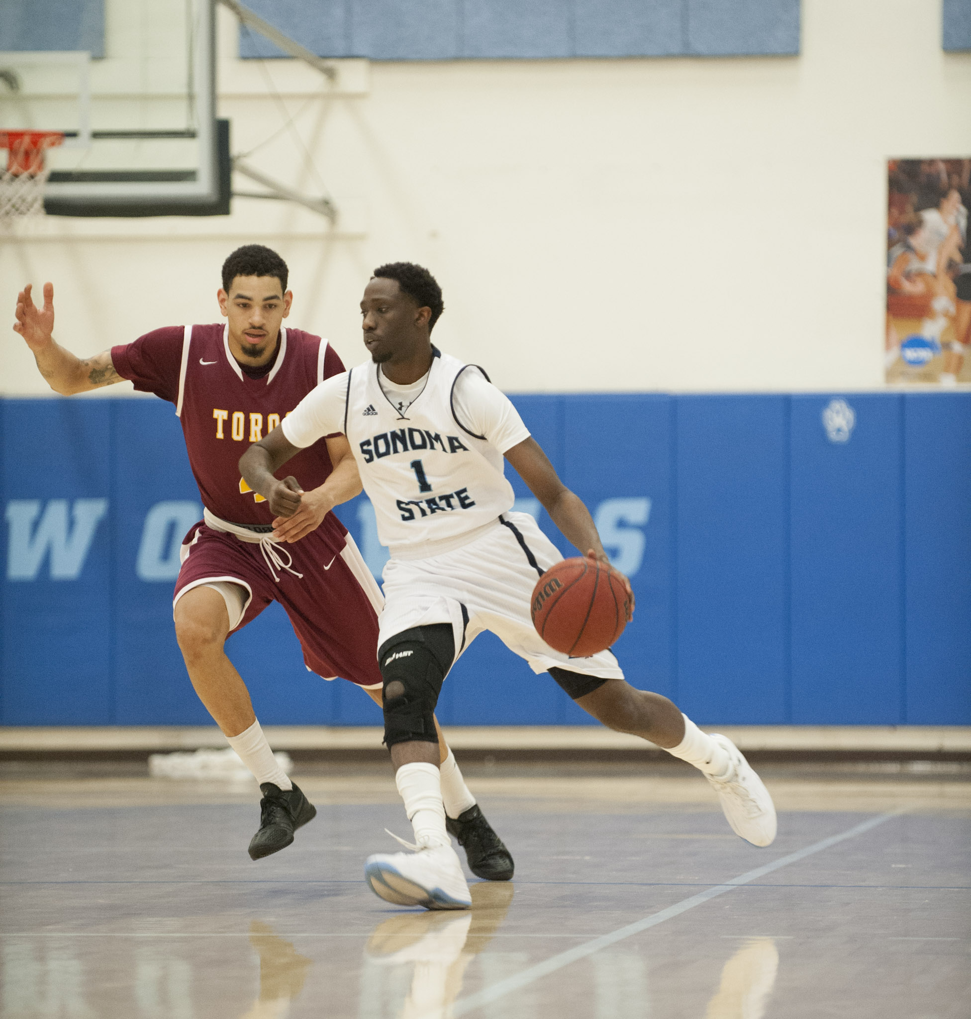 sonomaseawolves.com Junior Jabri Jenkins drives left past the defender.