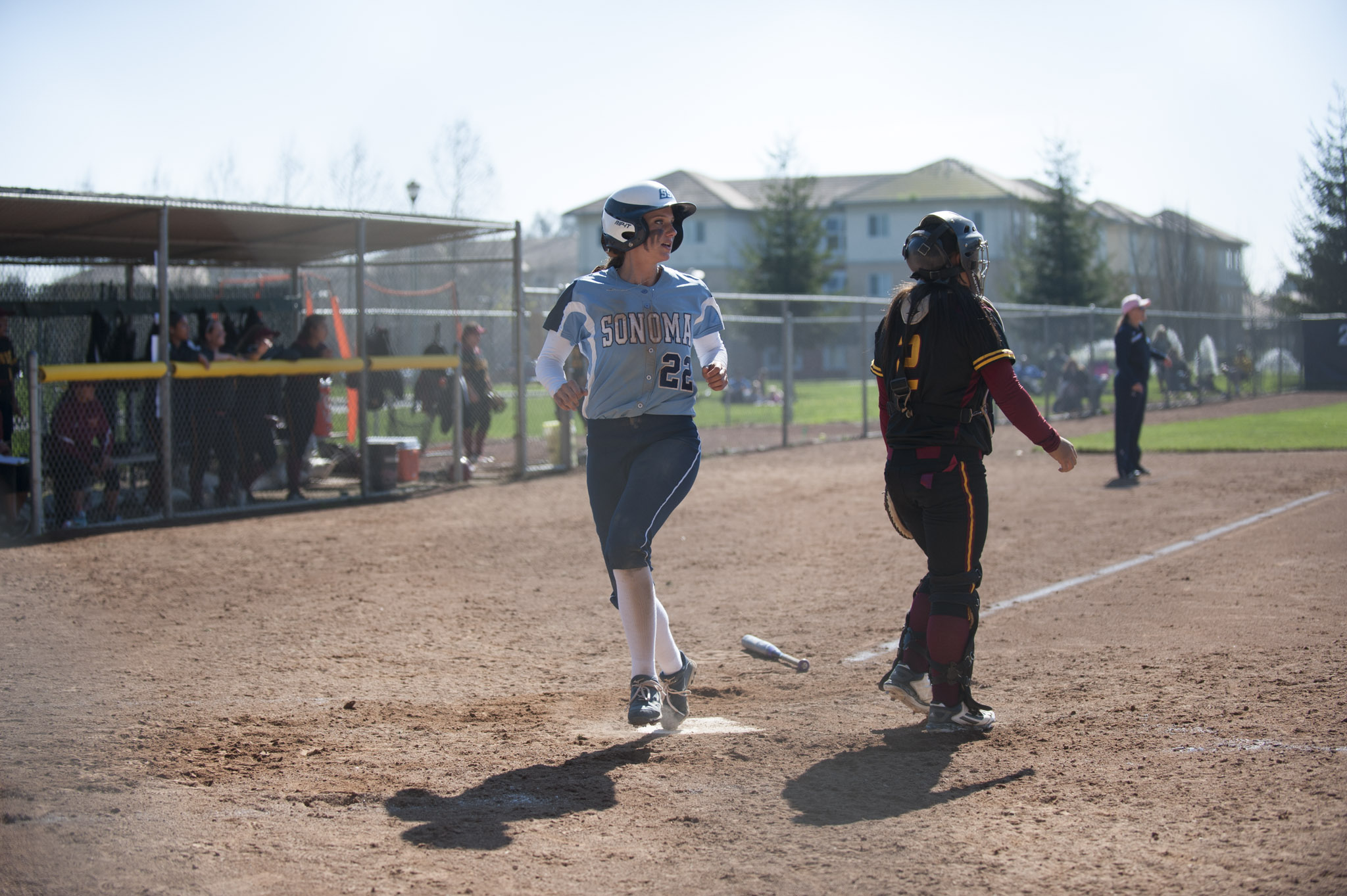 STAR // Connor Gibson Senior Holli Brown crosses the plate. Junior Amanda Llerena (8) and senior Amanda Rosetta (16) keep it light on the field.