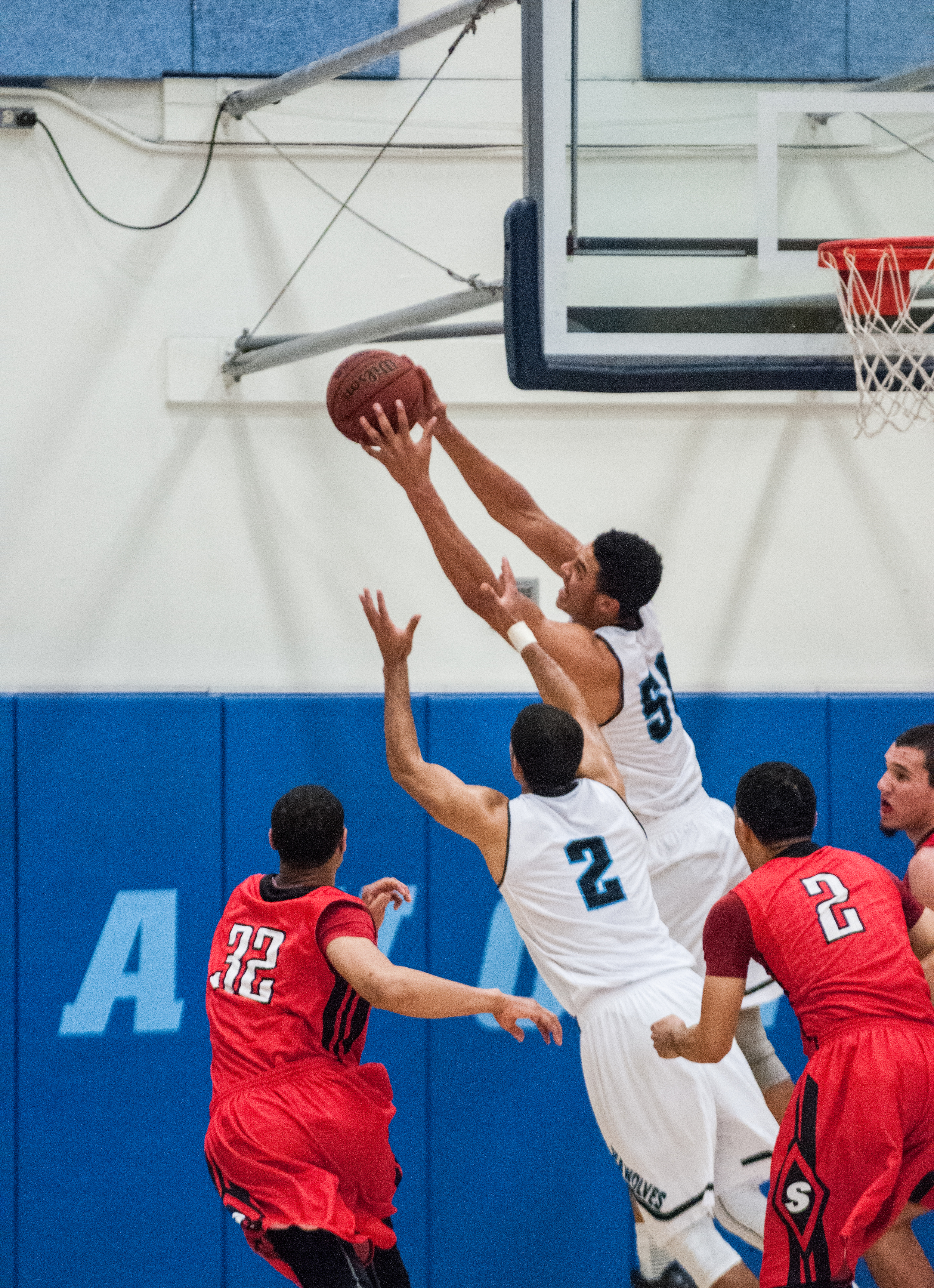 STAR // Gustavo Vasquez Junior forward Andy Mitchell grabs a rebound, sophomore guard Khalid Johnson takes the ball upcourt court. Sophomore center Nathan Molony-Benjamin fights for a rebound, Johnson controls the offense.