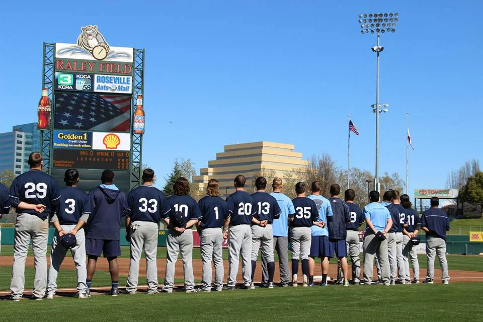 facebook.com The baseball team lines up for the National Anthem at Raley Field in Sacramento. The team enters the dugout before the start of the game.