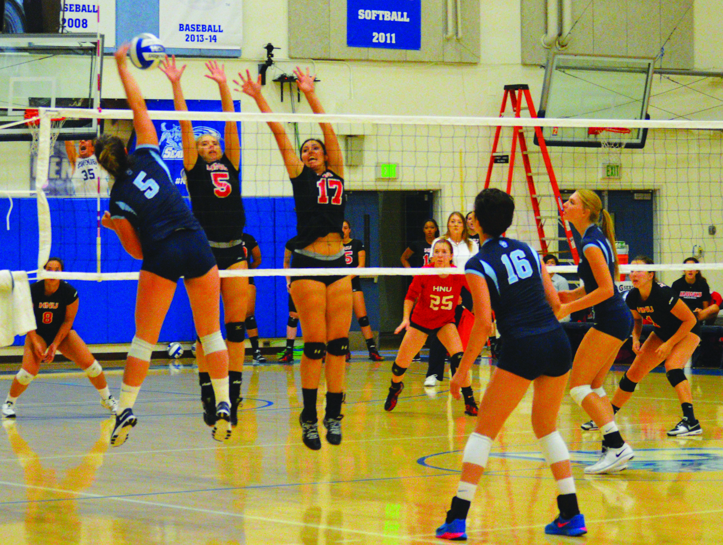 Senior Caylie Seitz goes for the kill against Holy Names University defenders in the Seawolve’s home opener. 