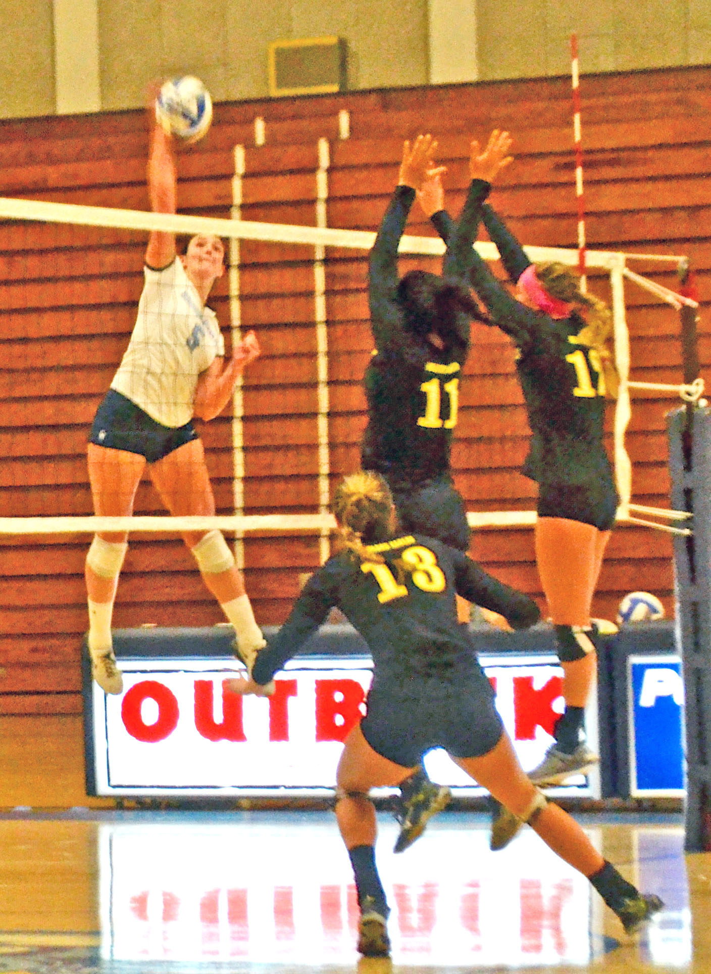 Senior Caylie Seitz goes for the kill in between three defenders. 