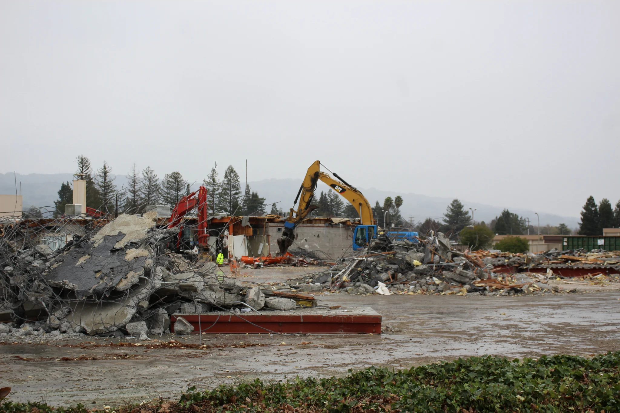 Demolition crews work to dismantle the State Farm campus on Friday, Feb. 8.