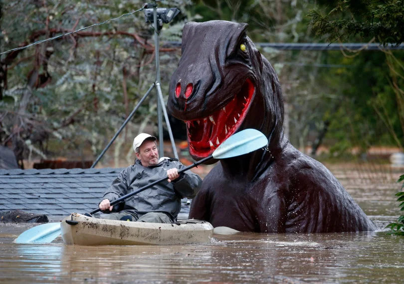 Rich Wilson, seen above, is seen paddling through floodwaters that severely damaged a local miniature golf course in Guerneville last month.