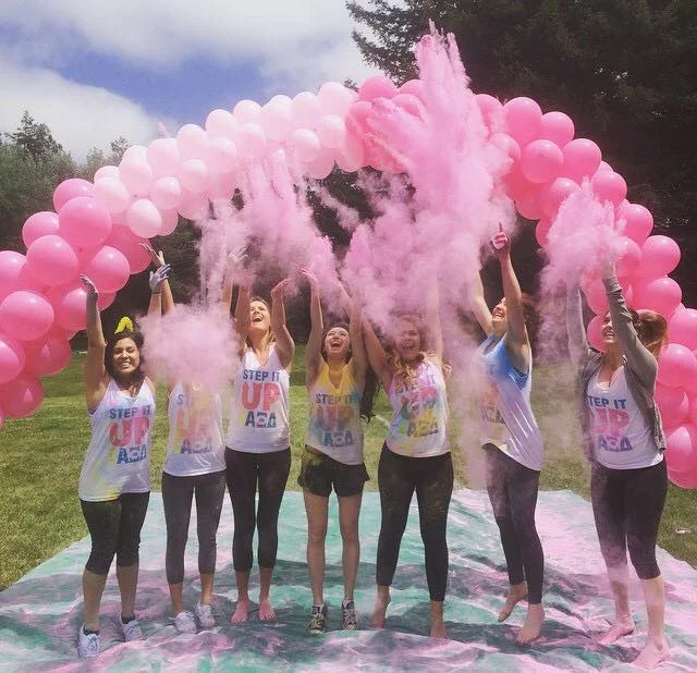 COURTESY // Alpha Xi Delta Members of the sorority Alpha Xi Delta celebrate with colored chalk at a past Step It Up event.