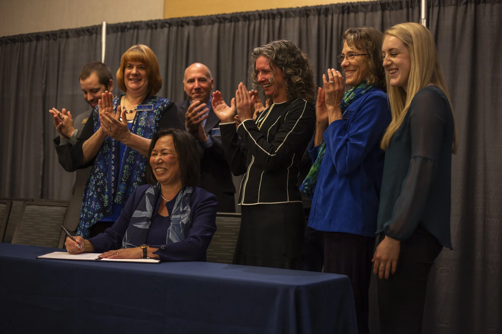 President Judy Sakaki, seen above signing the Climate Pact, spoke at length about climate change its impact on all of us during a ceremony on Friday, April 5.