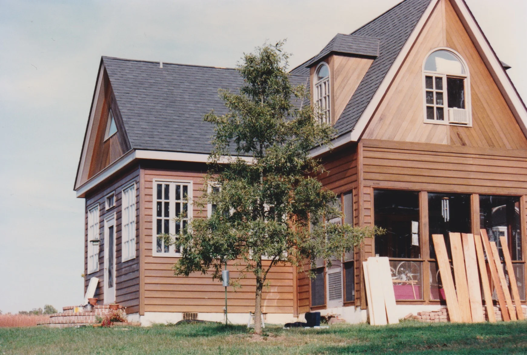 The front part of the original house, showing the front door, the bookroom windows, the porch and the south bedroom above.