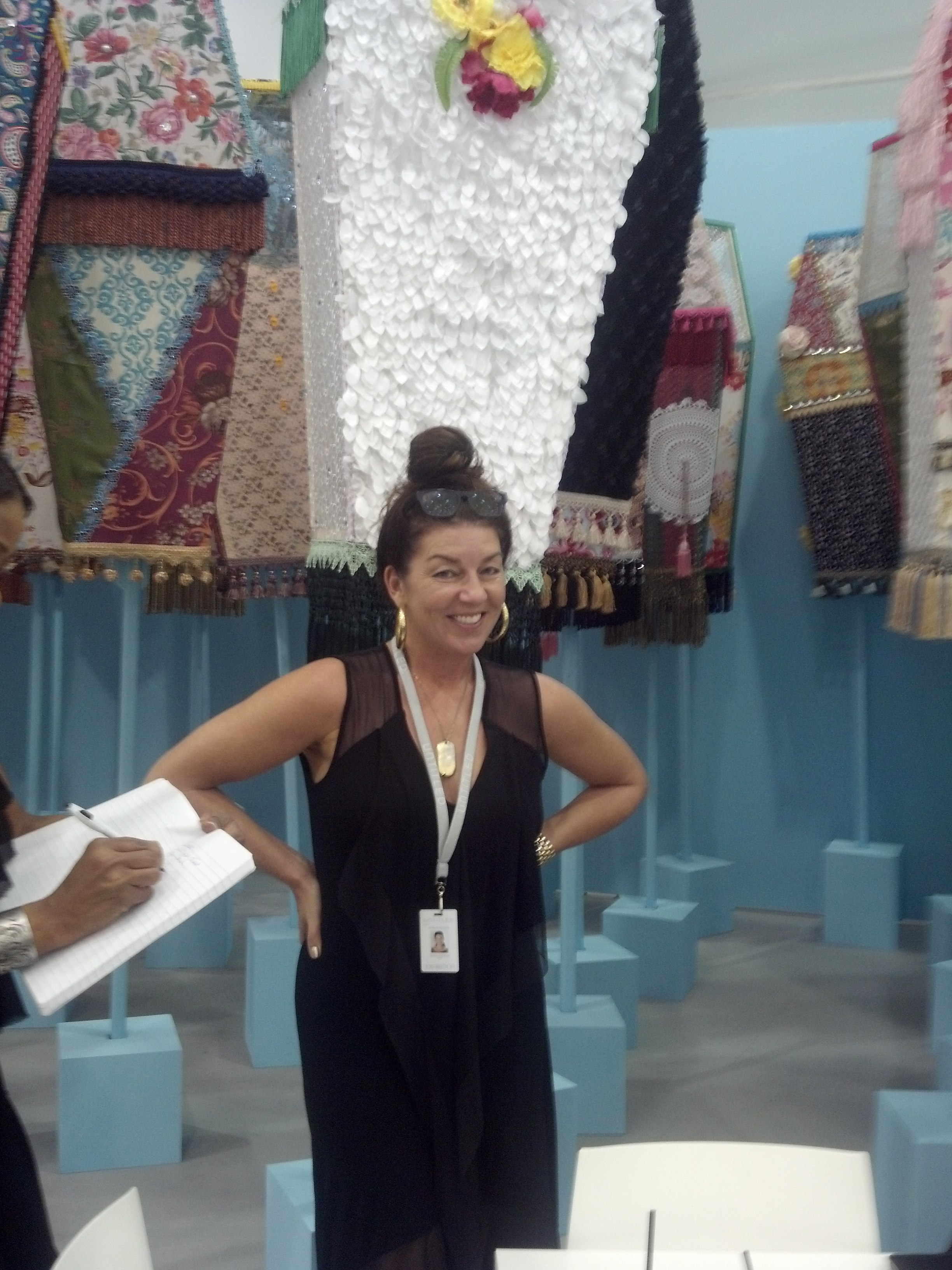 Monique Meloche in her booth at Untitled with an installation by Ebony G. Patterson