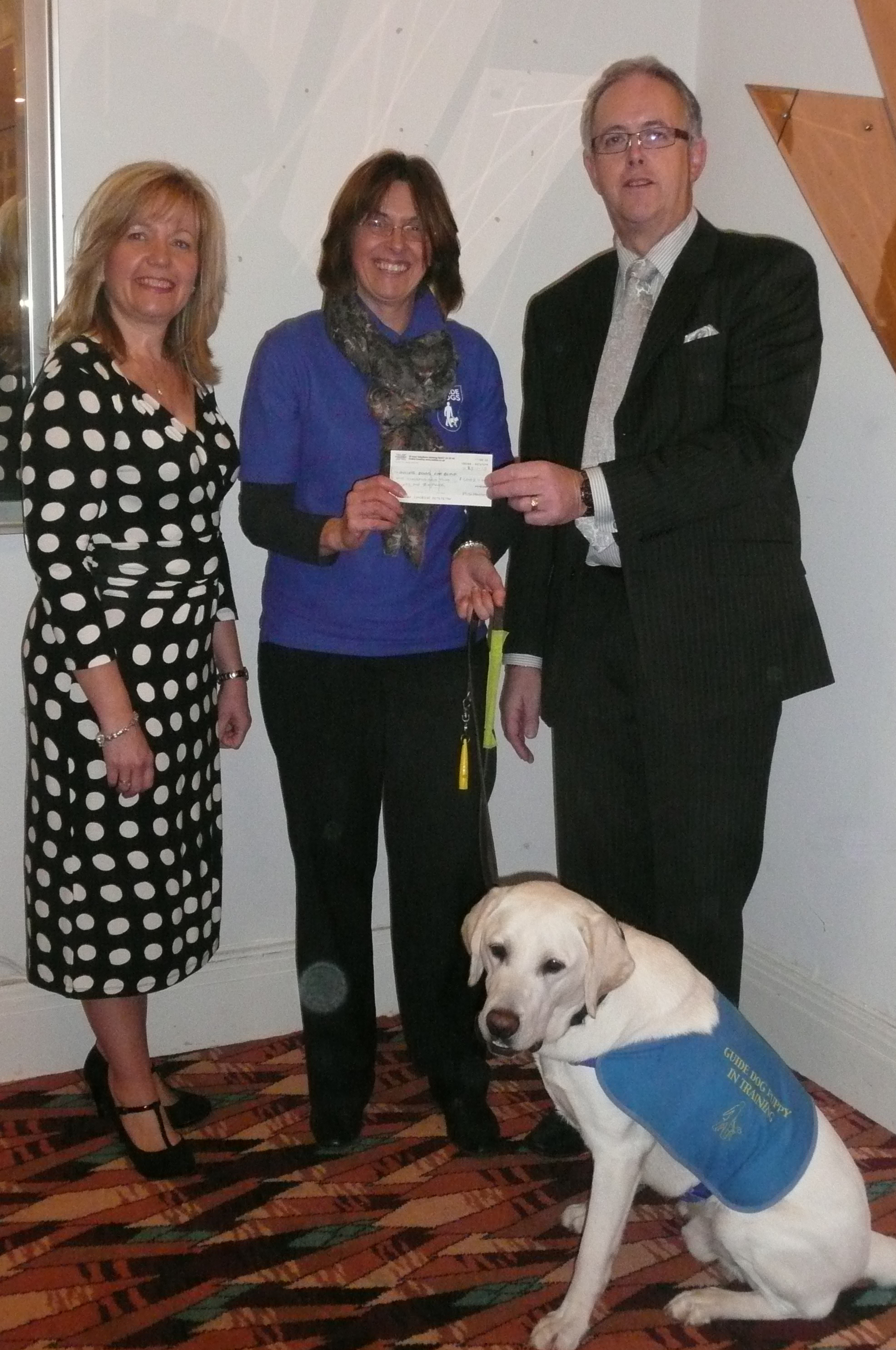 Mark and Tracey Helmore alongside Linda and guide dog puppy Weston