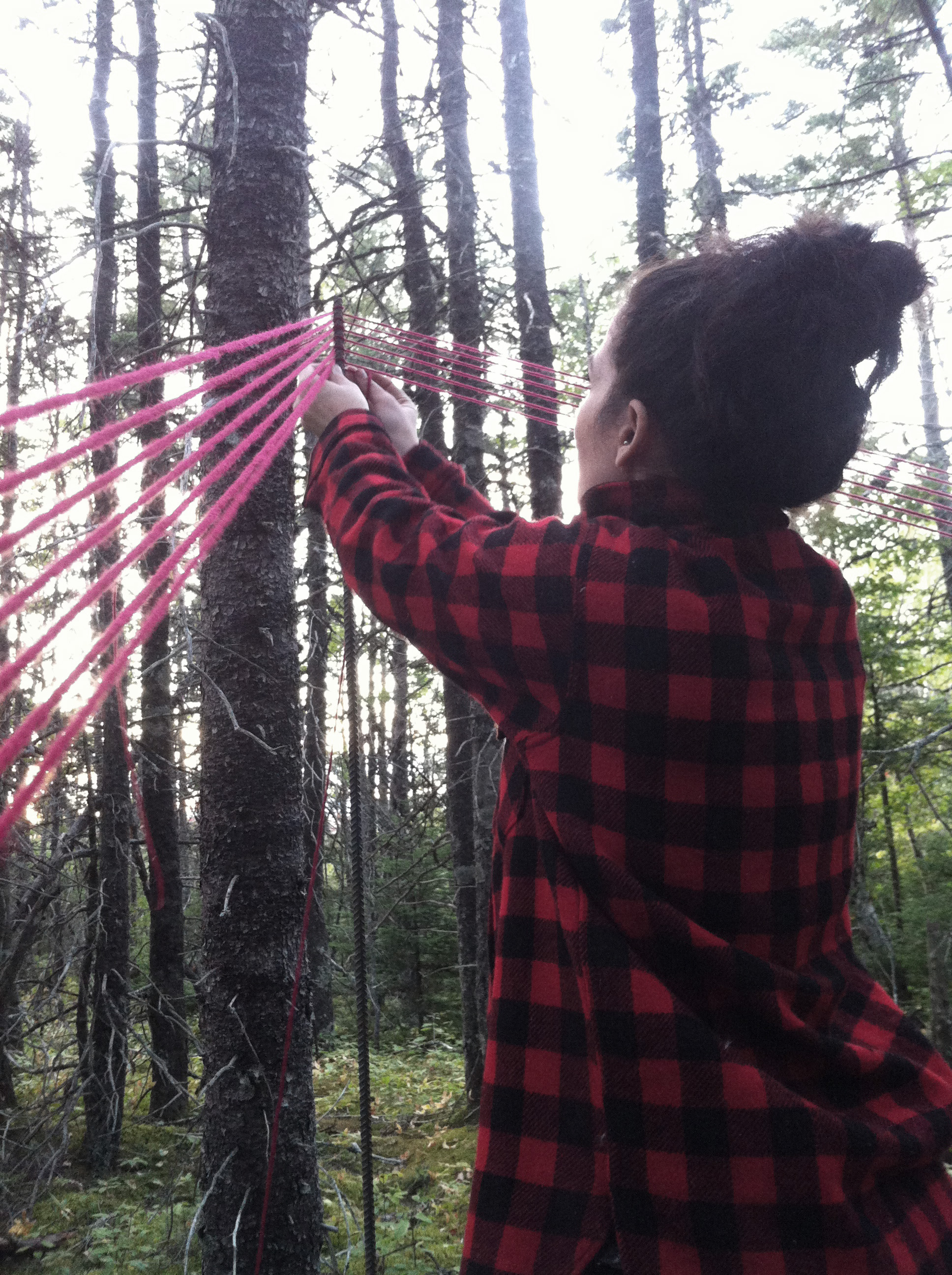 Meghan getting started tying the first few lengths of yarn.