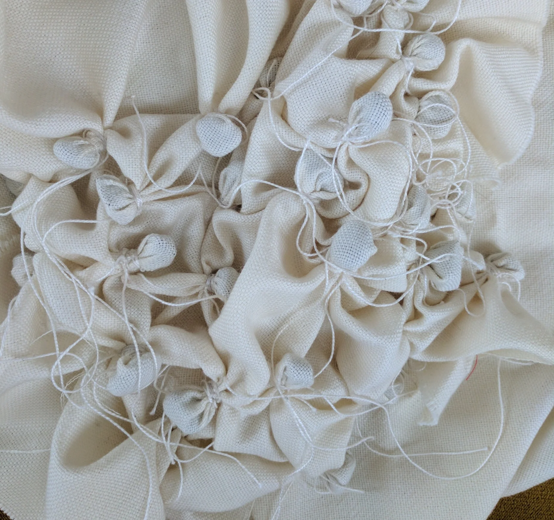 Wrap cotton around the pebbles to secure them in the fabric.