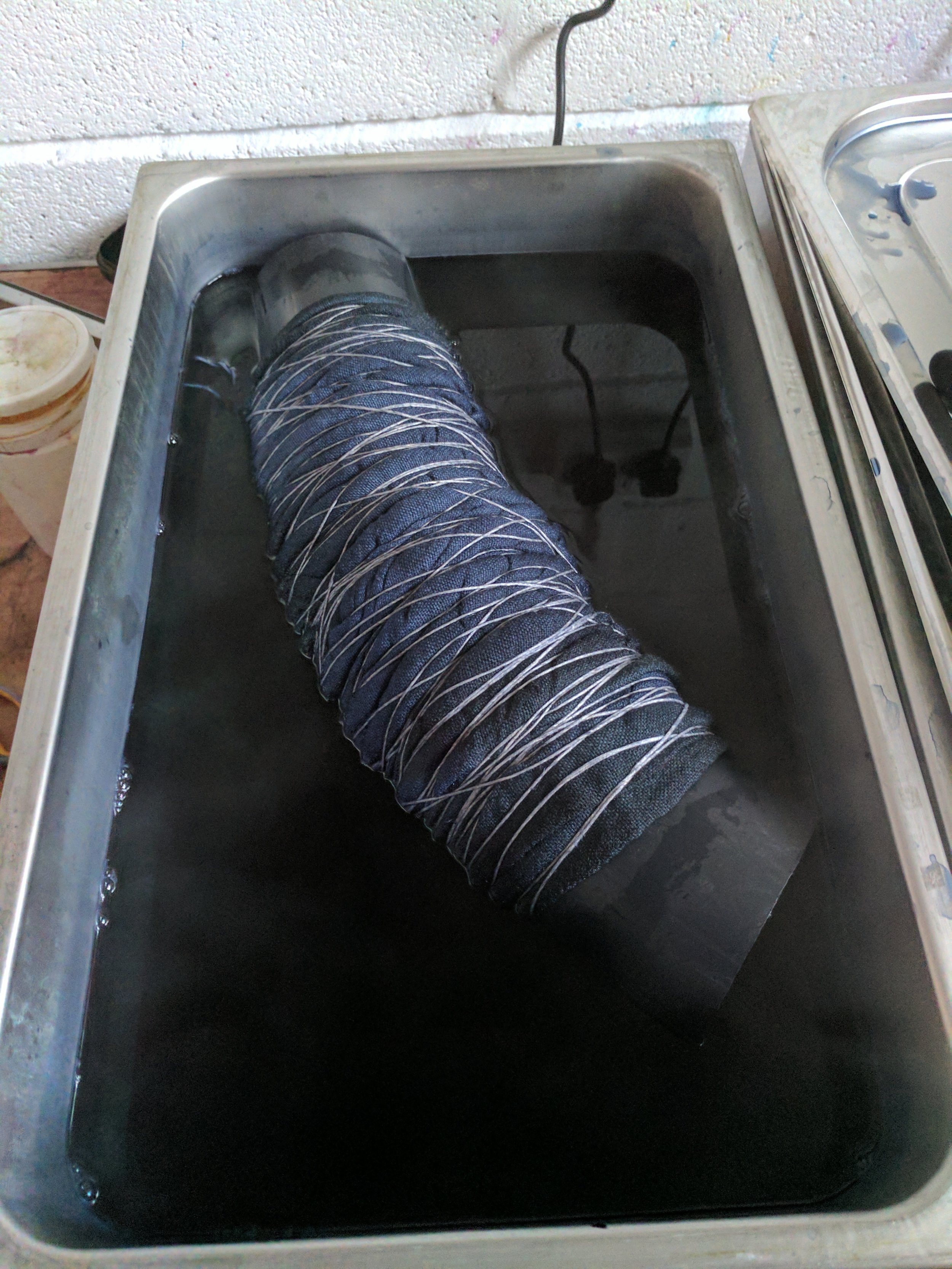 Pop the fabric into the dye bath, and then turn it over every so often in the dye.