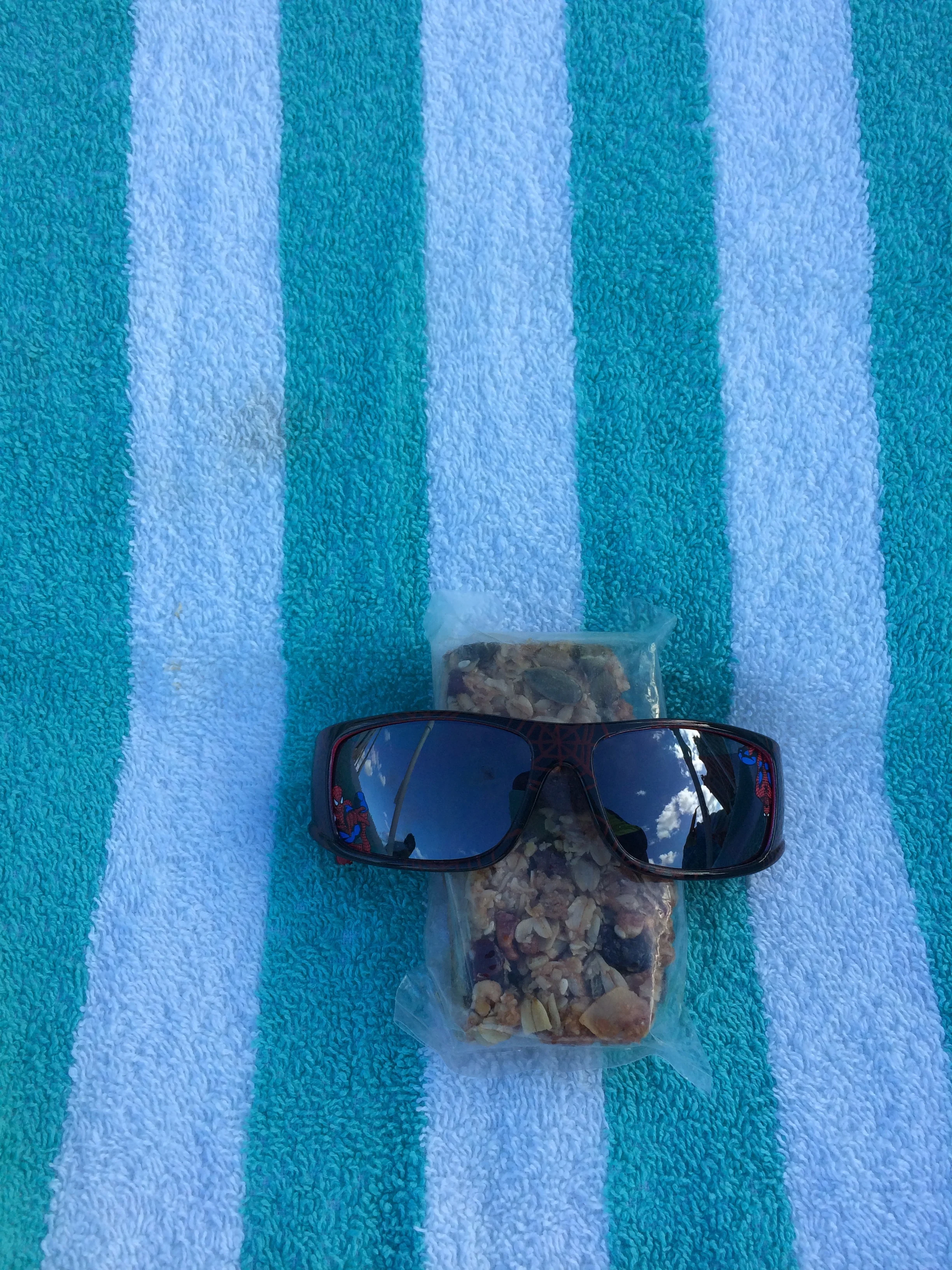 Sana from Houston, Texas sent this photo from her vacation on Paradise Island in Bermuda. Striped beach towel, Spidey shades, Nuts and Glory granola bar....paradise!!