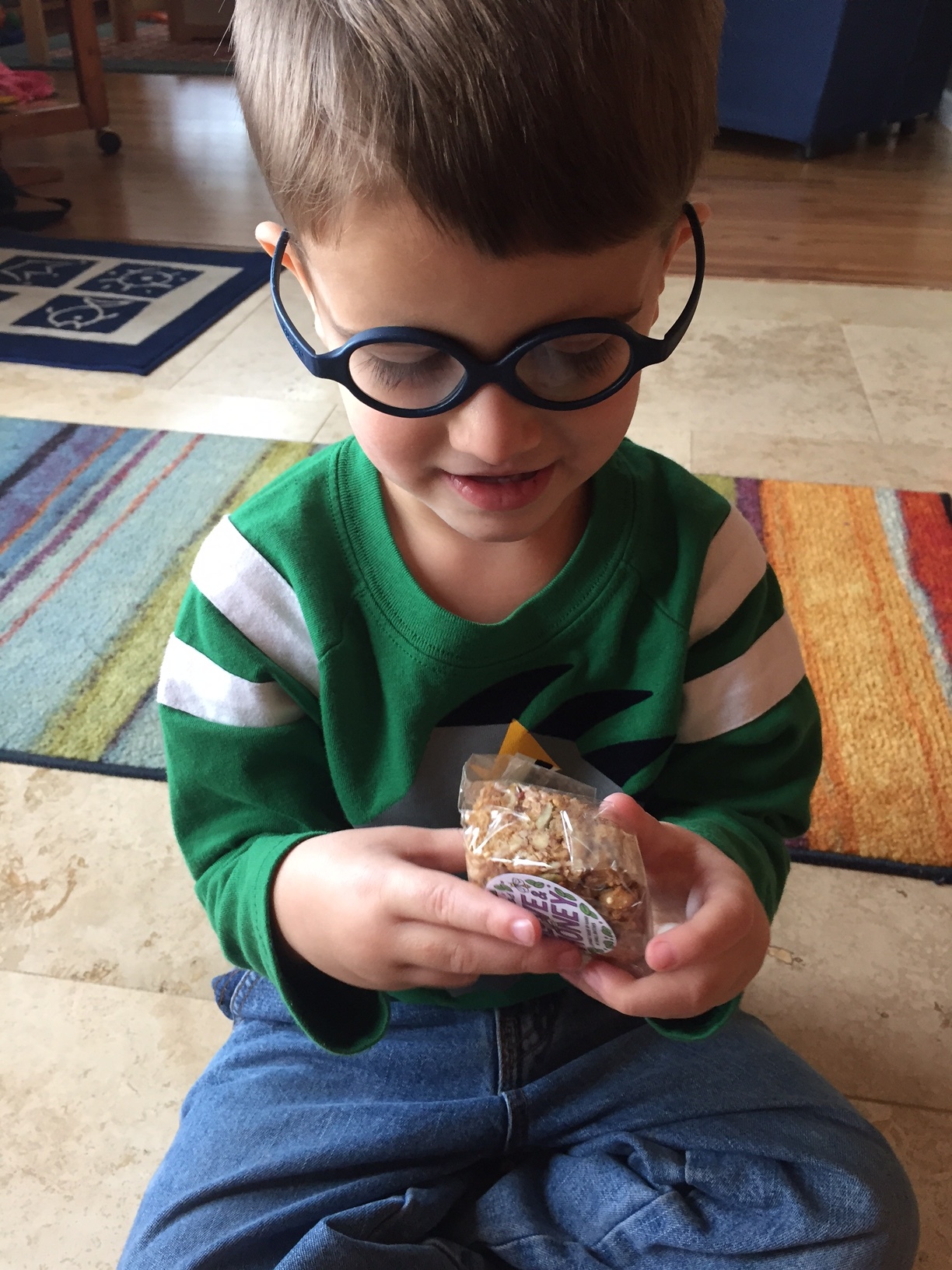 Holly from Alaska sent this photo of her little man unwrapping a "For Love and Honey" granola bar. Can he possibly be any cuter?!!