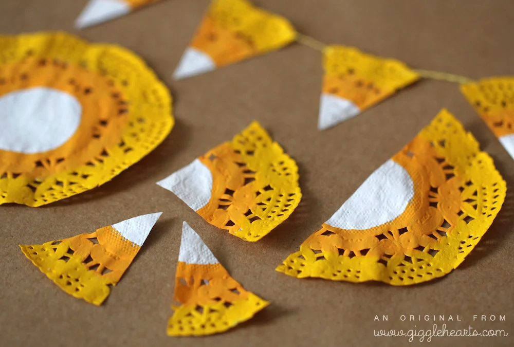 DIY Candy Corn Garland / simply paint, cut like a pizza and string together / from www.GiggleHearts.com