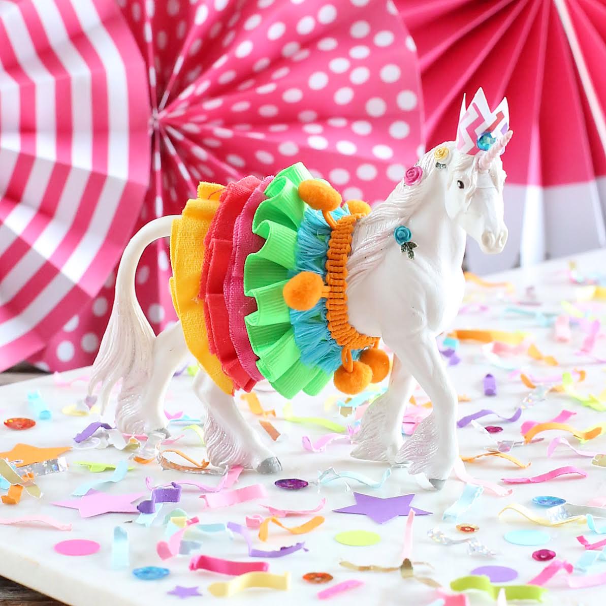  Colorful Unicorn Must-Have Party Items for a Perfectly Styled Unicorn Theme Dessert Table - a sweet Unicorn Animal Cake Topper and Festive Fetti Confetti - from The Bakers Party Shop - see more on www.GiggleHearts.com 