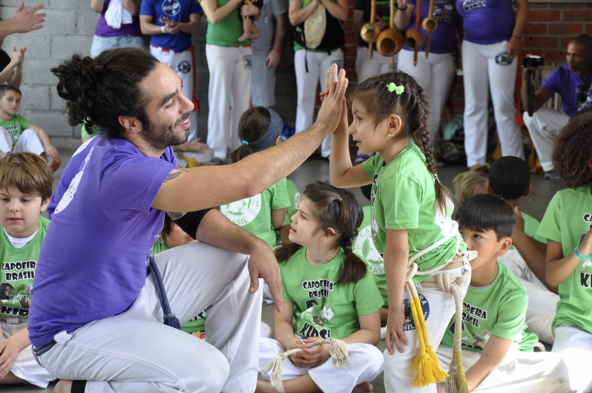 Instrutor Quebrado celebrates with a young student at the youth Batizado (Annual graduation)