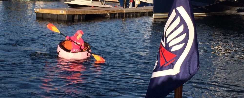 Jess from Belle's Cafe paddles across the inner basin as part of Newport Shipyard's annual Pink Pumpkin Regatta to raise money for breast cancer awareness.