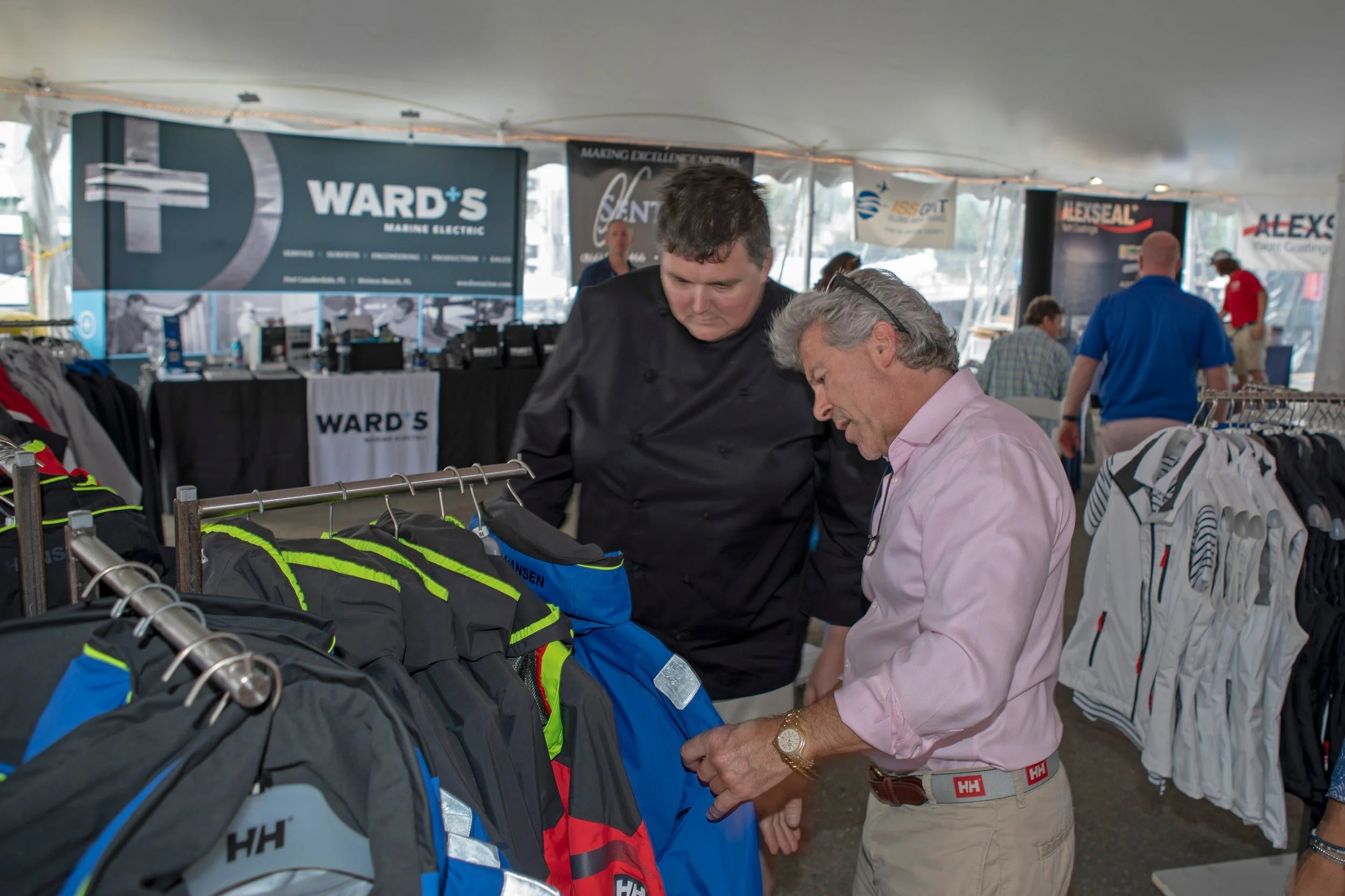 Jay Lasky, owner of Helly Hansen Newport, shows chef Shaun Byers of the M/Y Domani Helly Hansen gear at the Newport Charter Show.