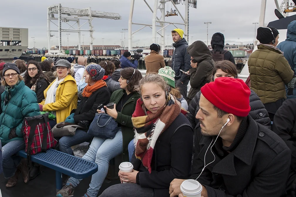 The audience listening to the performance through their-- on the Ferry Between San Francisco and the Port of Oakland. 