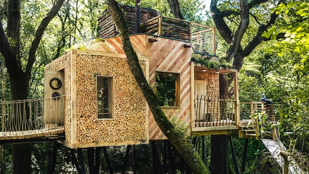 The slide can be seen to the right, there's a hot tub on the roof and access to the Woodsman's Treehouse is gained via an oak door with submarine locking system(Credit: Mallinson)
