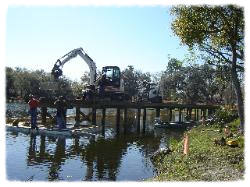 The decking is hooked up, swung into place and fastened to stringers.