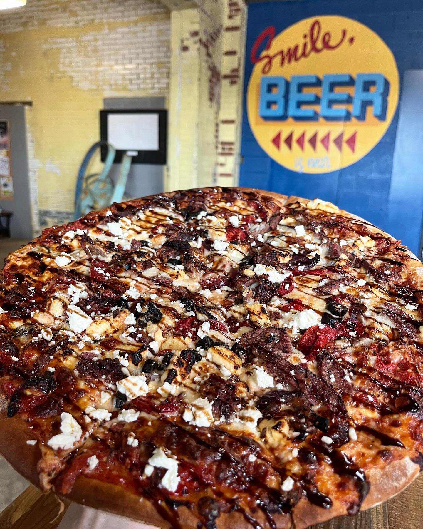 What goes together better than pizza and beer?! This pizza Thursday we&rsquo;ve got a doozy of a special for ya!  Todays specialty pizza is topped with San Marzano Tomato Sauce, Mozzarella, Skirt Steak, Caramelized Onion, Roasted Red Pepper, Feta, an