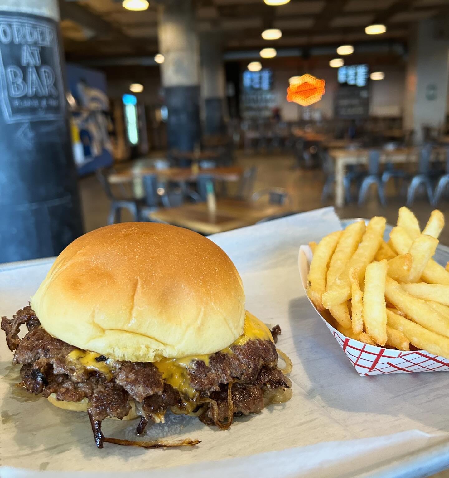 This week&rsquo;s Burger of the Week is our take on the Oklahoma Onion Burger!  We take 2 4 oz beef patties and press them on the grill with thinly sliced white onion.  That gets smothered in Mustard BBQ sauce then topped with American cheese and pla