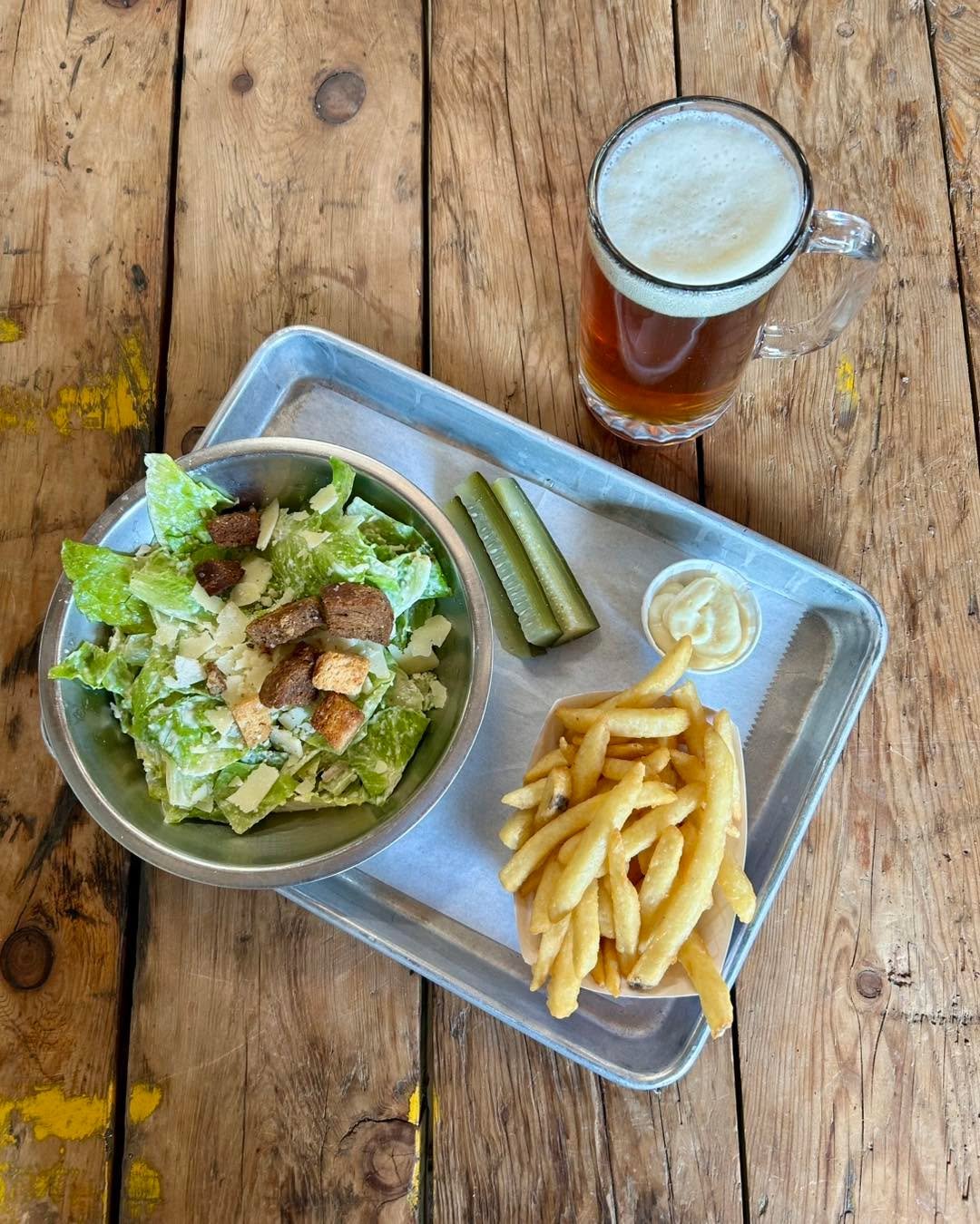 Galentine&rsquo;s Day is this Friday, so of course we&rsquo;re planning to have our version of girl dinner!  Enjoy a Caesar salad, fries with garlic mayo, some housemade pickles and a drink for $15!  Drink options include your choice of a beer, NA be