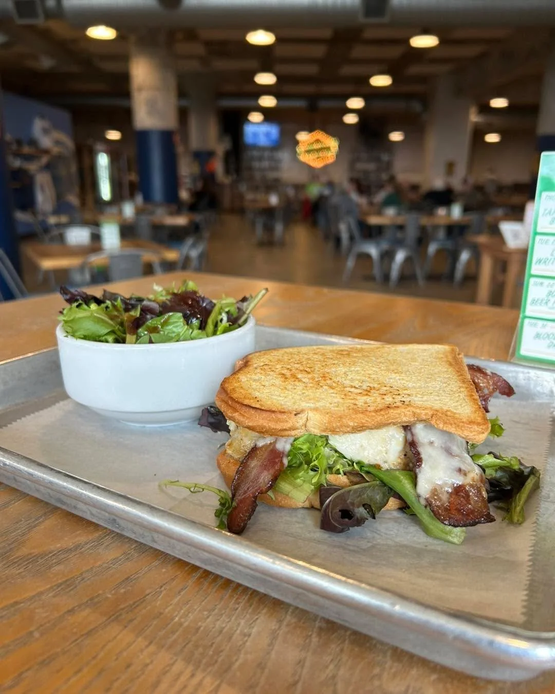 One of my favorites from the current seasonal menu - Chicken, Bacon, Etc - Grilled sourdough topped with grilled chicken breast, Swiss cheese, thick cut bacon, roasted tomato chili aioli, and mixed greens 🤤 

Maybe give one a try while you play Musi