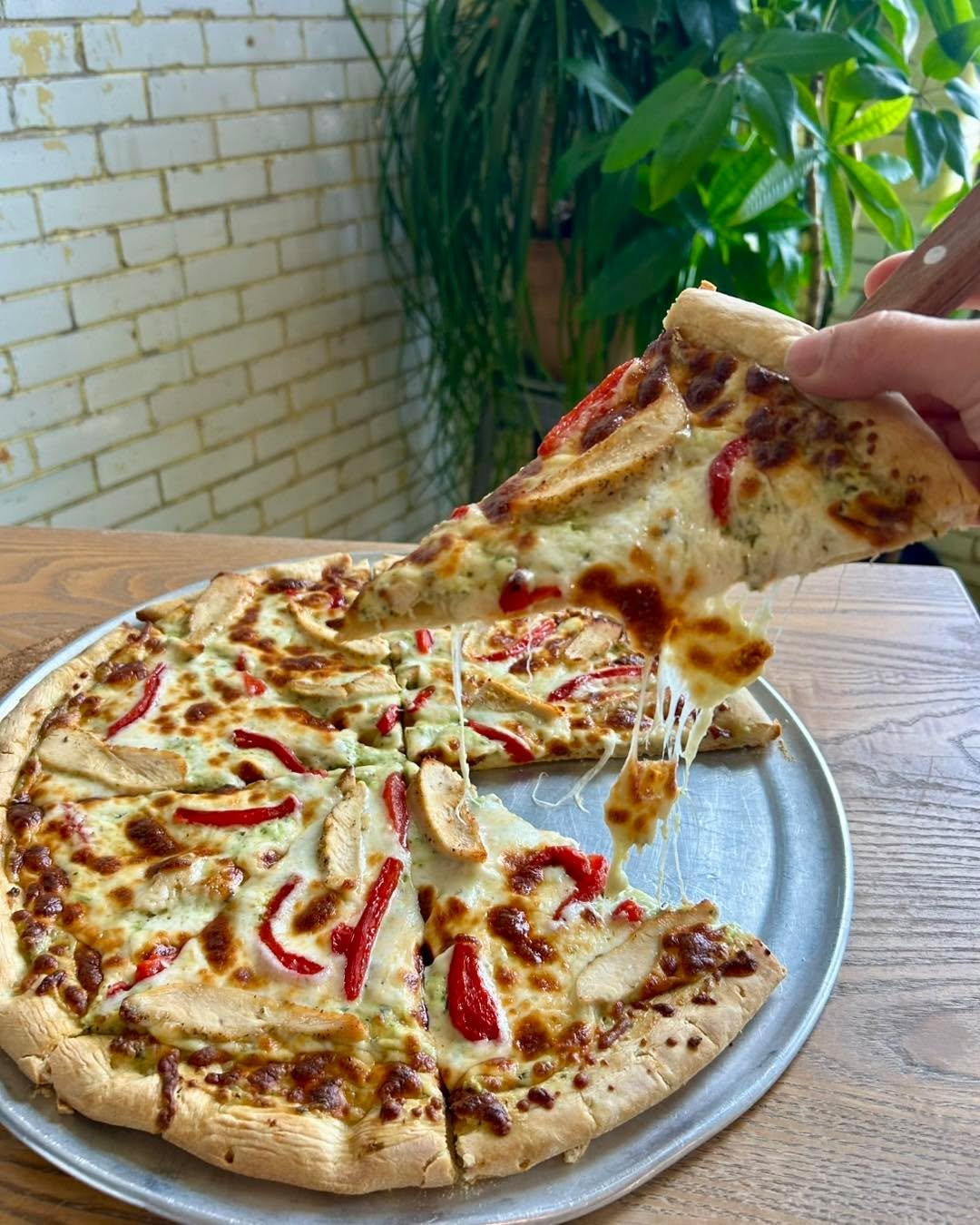 Happy Pizza Thursday!  Today&rsquo;s Specialty Pizza is topped with Creamy Basil Pesto, Mozzarella, Chicken, and Roasted Red Peppers. The basil came from my home garden - hope you like it!